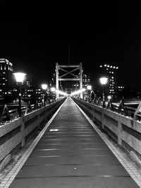 Illuminated bridge against sky at night