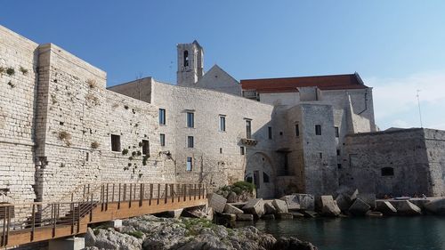 Buildings in city against clear sky