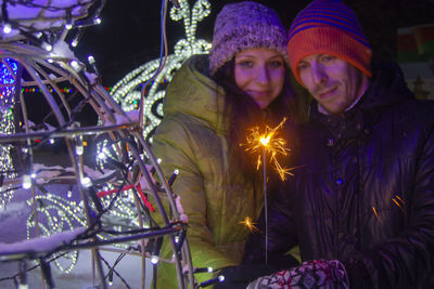 Portrait of smiling woman in winter at night