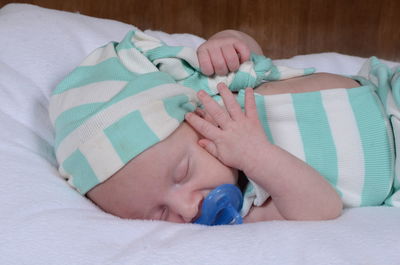 Close-up of baby sleeping on bed