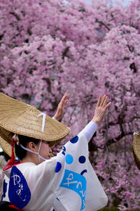 Low section of woman with cherry blossom flowers