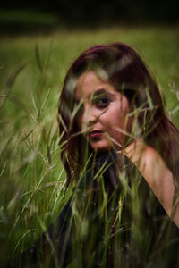 Portrait of young woman on field