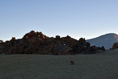 Rock formations in desert against clear sky