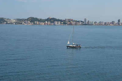 Sailboats sailing in sea against sky