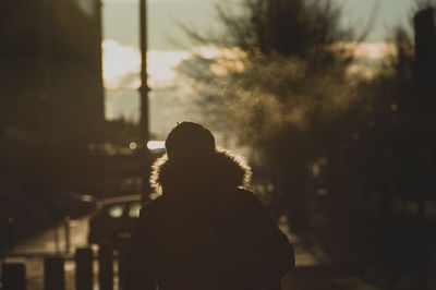 Rear view of person in warm clothing against sky