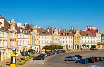 Buildings in city against clear blue sky