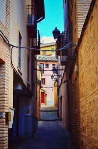 Narrow alley amidst buildings in town