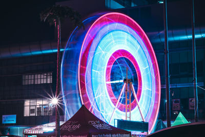 Illuminated ferris wheel at night