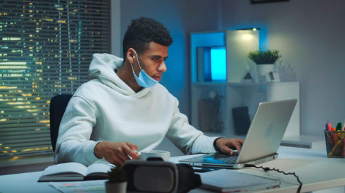 Young man using laptop at office