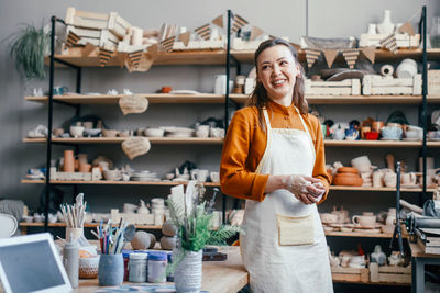 Portrait of a beautiful woman running a pottery studio