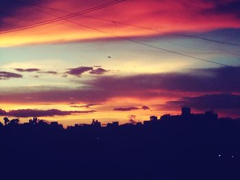 Silhouette of built structure at sunset