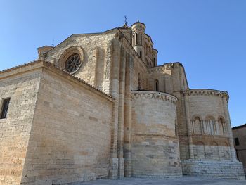 Low angle view of historical building against clear blue sky