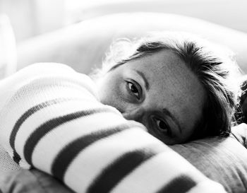 Portrait of girl lying down on bed at home