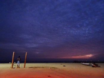 Scenic view of beach against sky at night