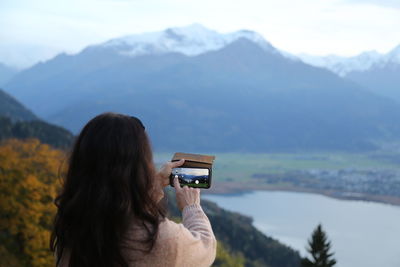 Woman photographing with mobile phone