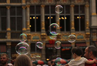 Rear view of people against bubbles