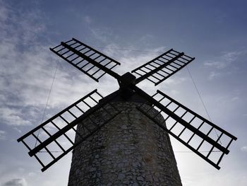 Low angle view of traditional windmill against sky