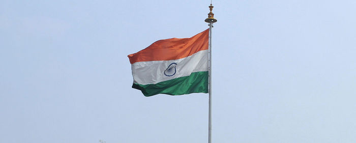 Low angle view of flag against clear sky