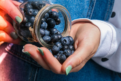Midsection of person holding fruit