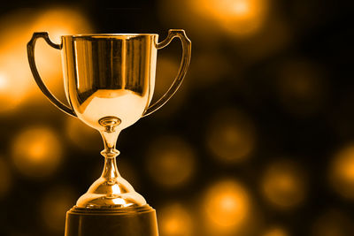 Winner hold trophy with abstract bokeh light background