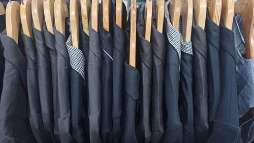 Black blazer and shirt on hanger racks