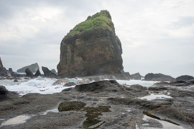 View of beach against cloudy sky