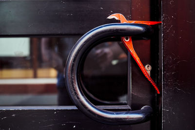 Close-up of work tool on metallic door handle