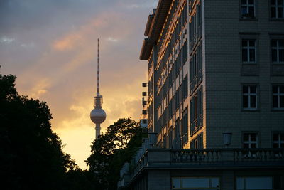 Fernsehturm against sky during sunset in city