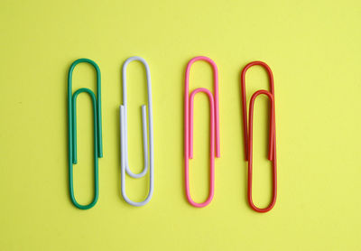 Close-up of colored pencils against yellow background