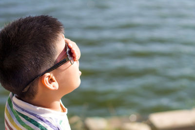 Close-up of boy covering his eyes