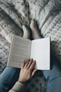 Low section of man reading book