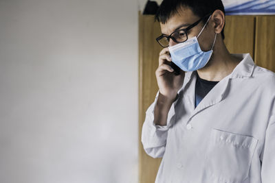 Male scientist using smartphone portrait