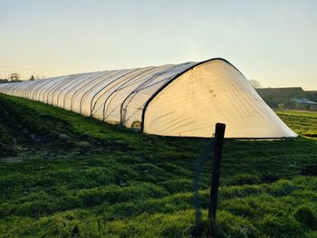 Built structure on field against sky