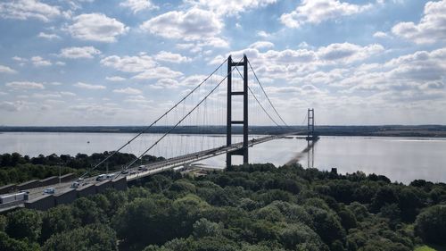 View of suspension bridge against cloudy sky