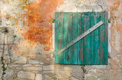 Wooden window on wall outdoors