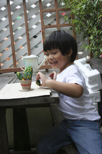 Smiling boy showing thumbs up