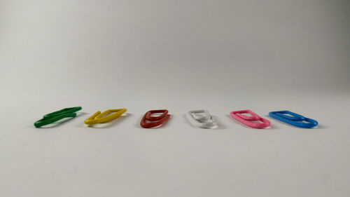 High angle view of multi colored pencils on white background