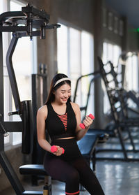 Shirtless man exercising in gym