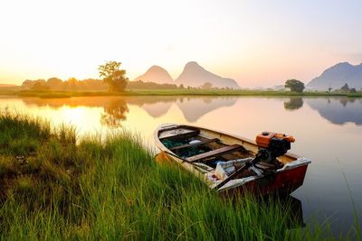 Scenic view of lake against sky during sunset