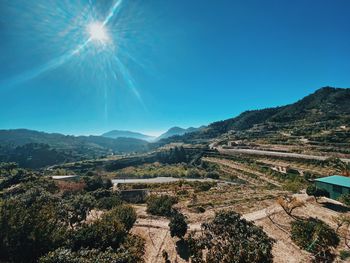 Scenic view of mountains against blue sky