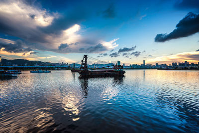 Barges in kowloon bay against sky