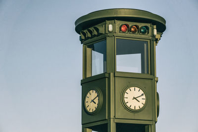 Low angle view of clock against clear sky