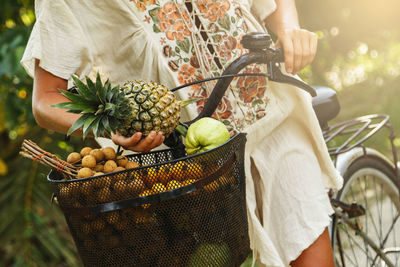 Midsection of woman holding pineapple