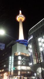Low angle view of illuminated tower at night
