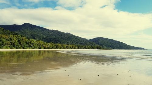 Scenic view of sea and mountains against sky