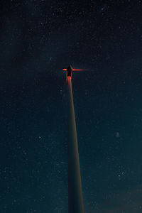 Low angle view of wind turbine against sky at night