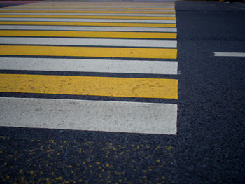 High angle view of yellow crossing sign on road