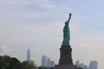 Statue of liberty with freedom tower in the background