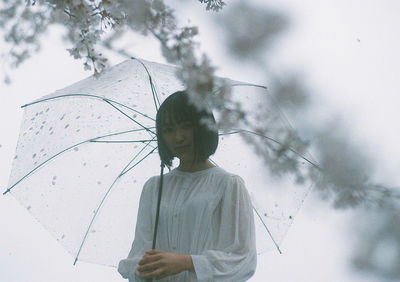 Rear view of woman standing against sky