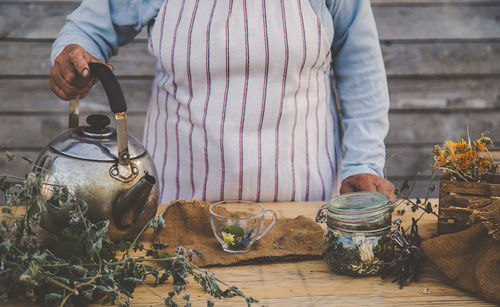 Midsection of man preparing food on table